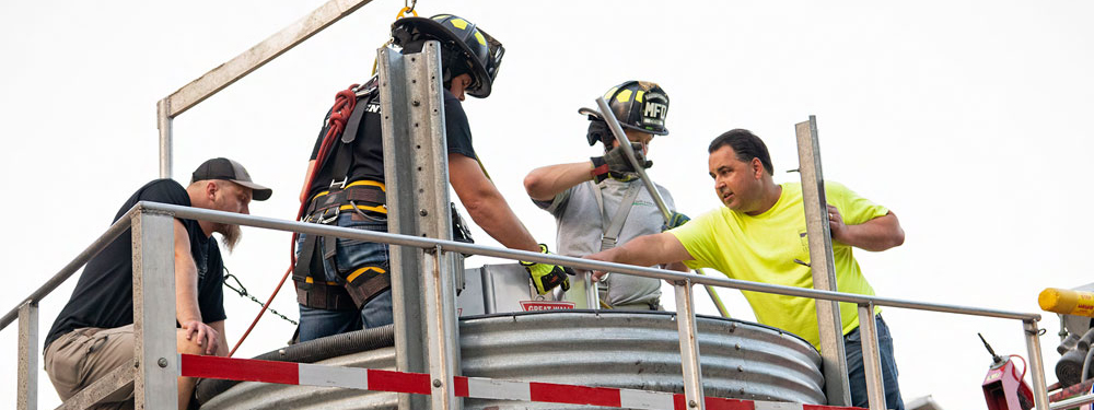 Firefighters performing a grain bin rescue exercise